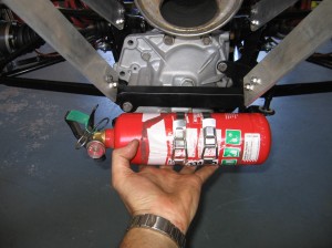 Holding the extinguisher where it needs to be.